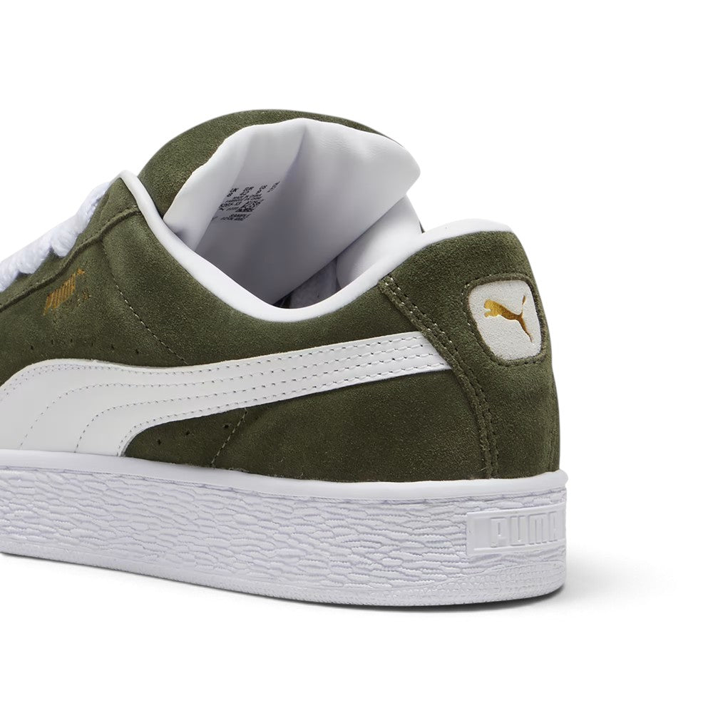 Close-up rear angle focusing on the reinforced suede heel counter, thick puffy Achilles collar padding, white leather heel moustache tab stamped with a gilded metallic PUMA Cat logo, and chunky textured cupsole base.