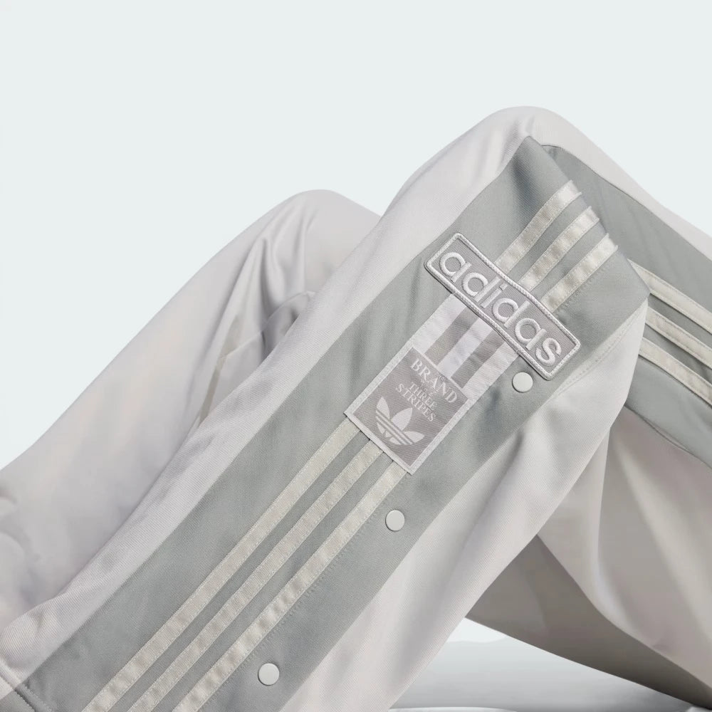 Emphasising the sharp visual contrast of the premium stitched retro Adibreak logo patch standing proud against the grey fabric backdrop.
