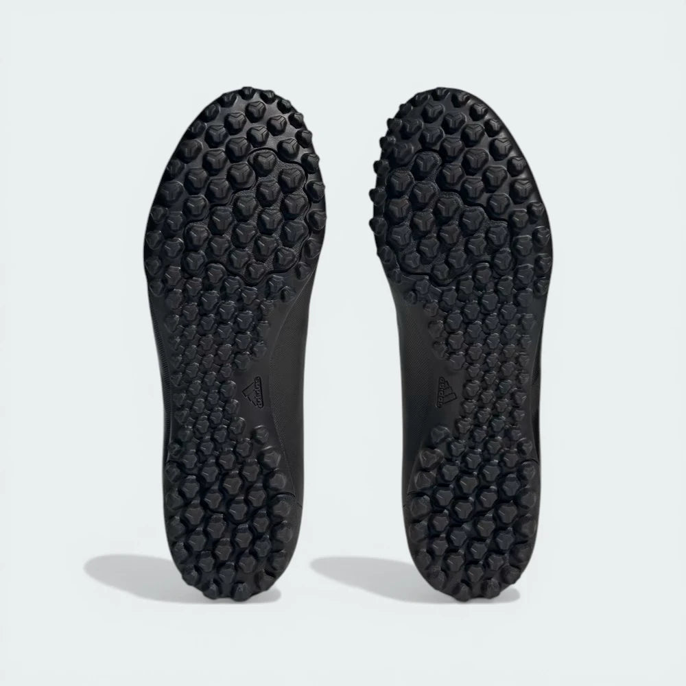 Outsole view of the lug rubber pattern, detailing the multidirectional grip designed for artificial turf.