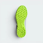Displays the technical lug rubber outsole layout designed for unreal multidirectional traction on artificial turf.