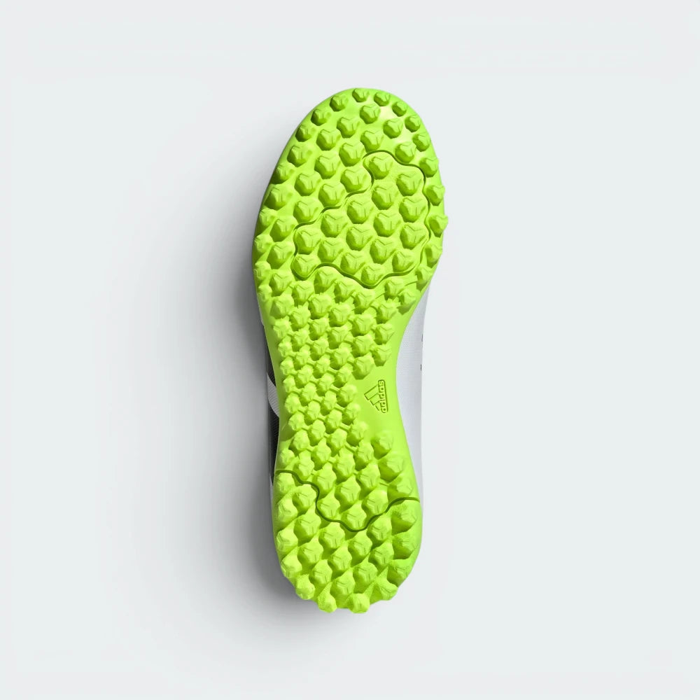 Displays the technical lug rubber outsole layout designed for unreal multidirectional traction on artificial turf.