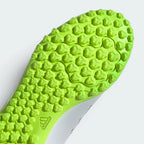 Close-up of a green textured sole with Adidas logo on a white background