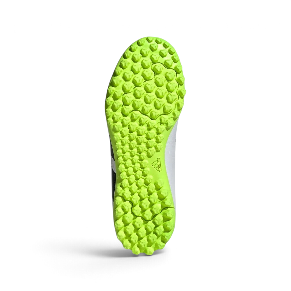 Displays the technical lug rubber outsole layout designed for unreal multidirectional traction on artificial turf.