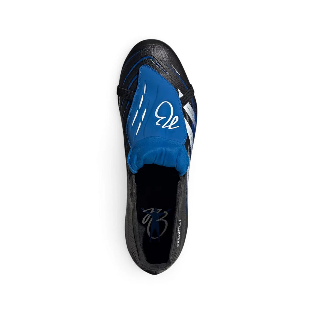 Overhead view looking down at the laced football boots, displaying the bright blue fold-over tongue secured by an elastic strap, featuring custom Jude Bellingham signature graphics across the top.