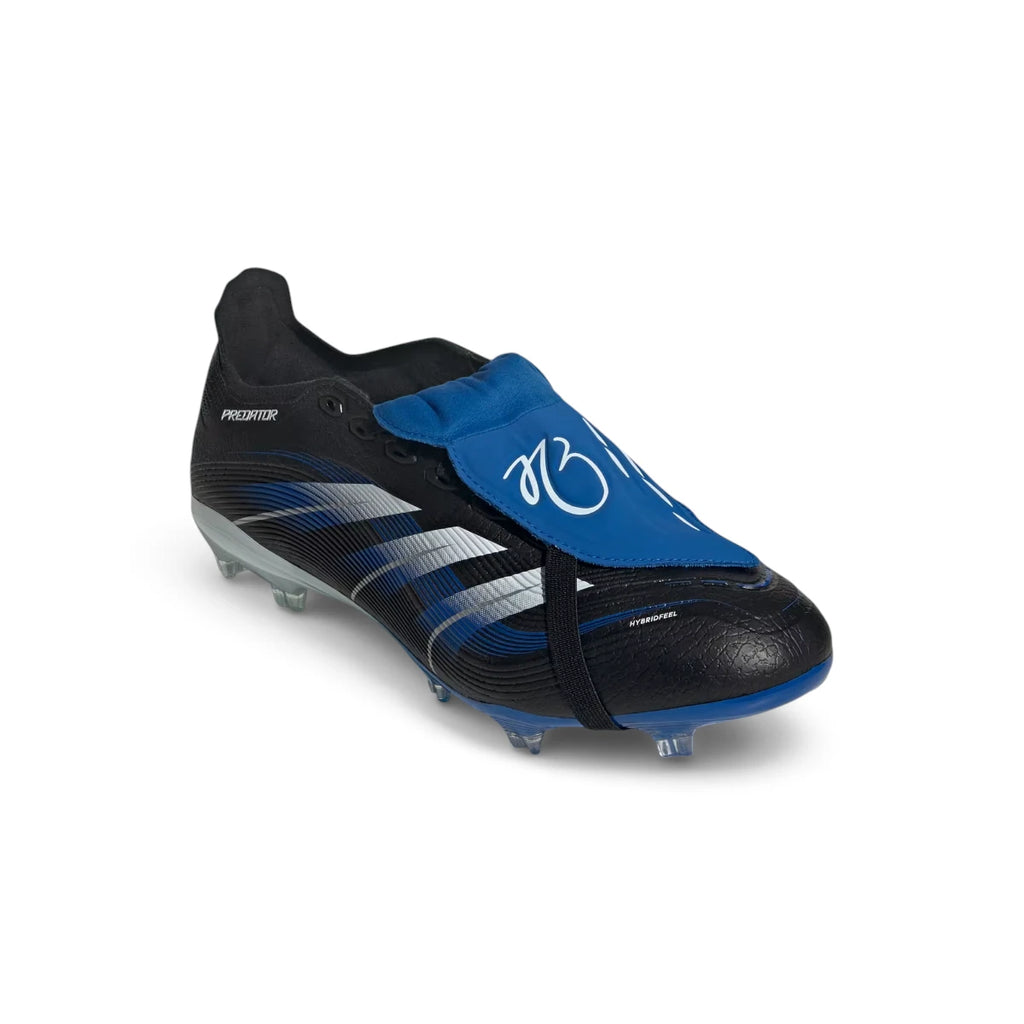 Dynamic front-three-quarter perspective capturing the textured strike zone, rubber Strikescale fins, and the sleek aerodynamic silhouette of the signature boot.