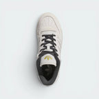 Focuses on the locked-in traditional lacing layout, displaying the perfect symmetry of the leather tongue, the printed adidas branding plate, and the intricate rows of perforations guarding the front toe box area.