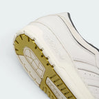 Highlights the "unreal" clean finish where the high-walled rubber cupsole walls securely bond to the tough leather upper framework.