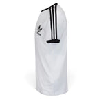 Side Profile Image: Studio lateral shot of the adidas California t-shirt in white and black, highlighting the raglan shoulder seam, black sleeve cuff, and continuous triple-stripe tape running down the arm.   