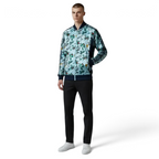 Man wearing a patterned jacket and black pants on a white background