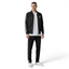 Focuses on the symmetry of the flat-laid track jacket, displaying the perfect alignment of the high stand-up funnel collar, the central zip track, and the balance of the embroidered Trefoil logo on the chest.