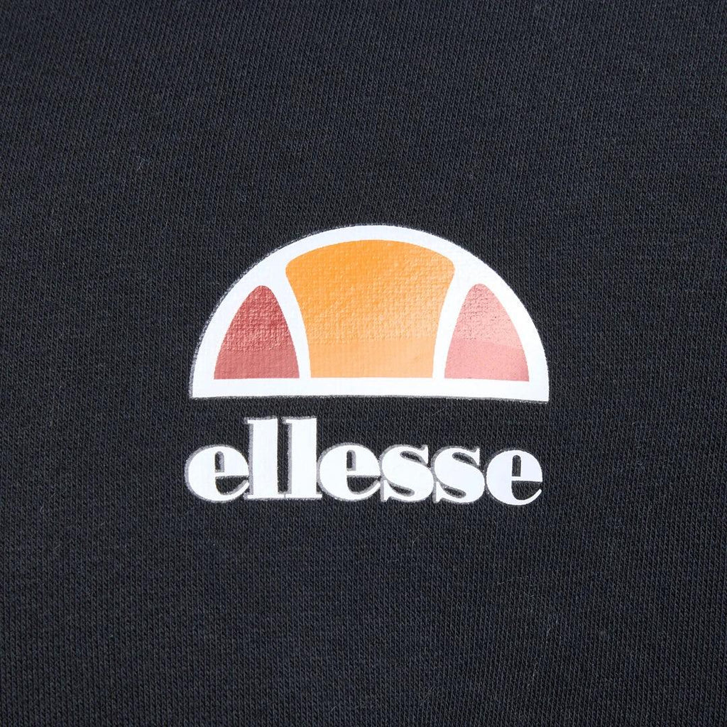 Close-up zoom on the fabric of the Ellesse Toce Overhead Hoodie in black, showing the soft fleece texture and the embroidered or printed Ellesse logo.