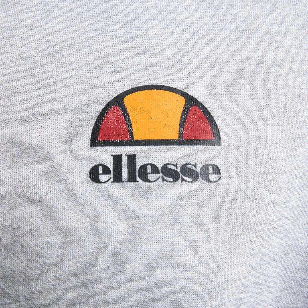 Close-up zoom on the fabric of the Ellesse Miletto Full-Zip Hoodie in light grey, showing the soft fleece texture and the embroidered or printed Ellesse logo.