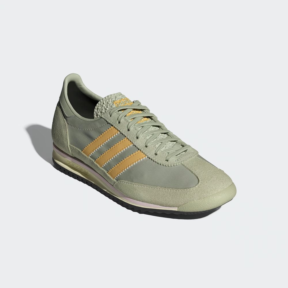 Emphasising the contrast between the Halo Green nylon and the soft Oat-coloured suede overlays.