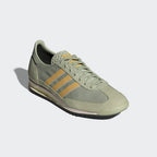Emphasising the contrast between the Halo Green nylon and the soft Oat-coloured suede overlays.