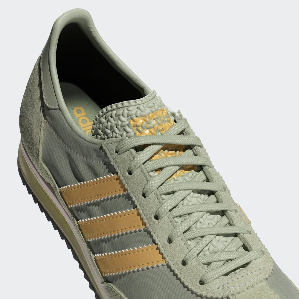 A close-up of the breathable nylon weave and the precision suede stitching on the toe cap.