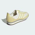 Focusing on the Power Yellow heel tab and the streamlined EVA midsole wedge.