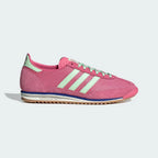 The Pink Fusion SL 72 OG, highlighting the slim profile and the vibrant Semi Green Spark Three-Stripes against the pink nylon.