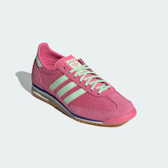 Emphasising the contrast between the pink nylon and the premium green suede overlays.