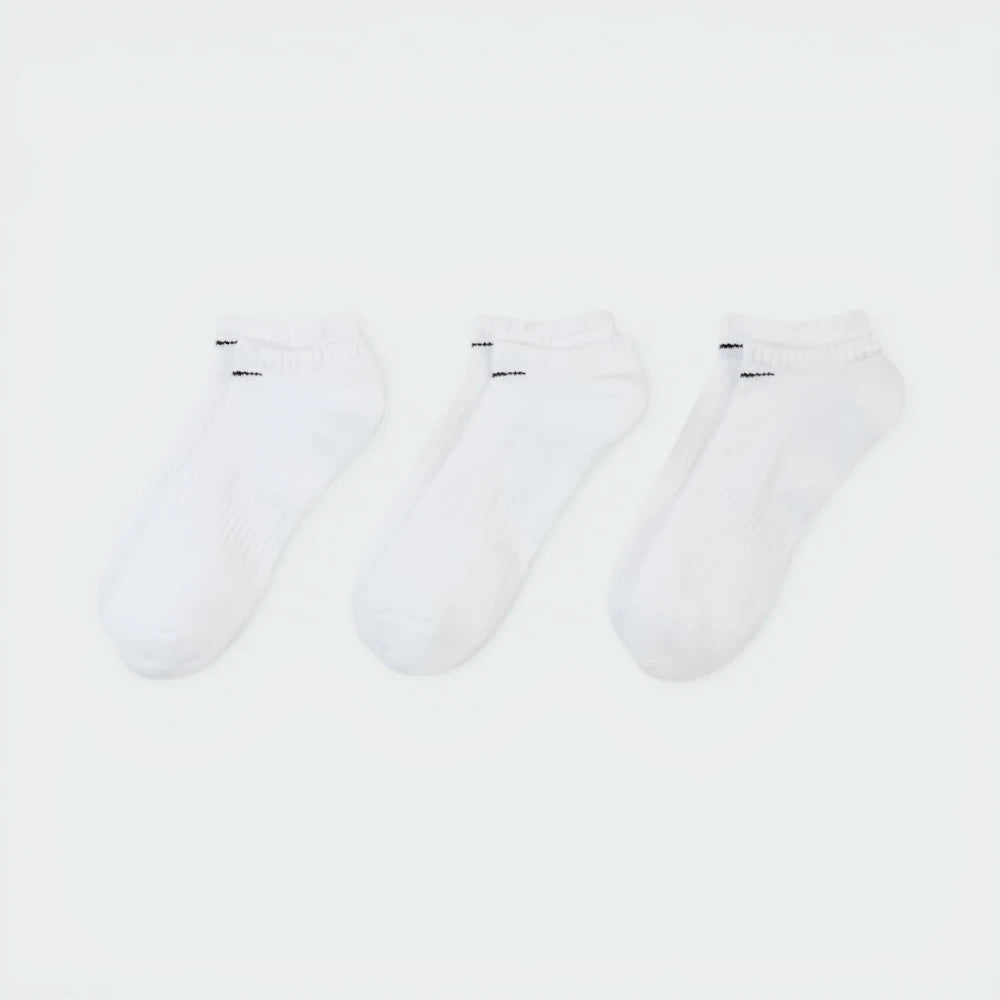 Looking down at the three pairs laid out, showcasing the uniform white knit and the ribbed arch band detail.