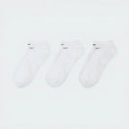 Looking down at the three pairs laid out, showcasing the uniform white knit and the ribbed arch band detail.