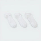 Looking down at the three pairs laid out, showcasing the uniform white knit and the ribbed arch band detail.