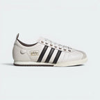 Highlights the high-velocity sweep of the Core Black serrated 3-Stripes and the professional, gleaming depth of the metallic gold foil Samba branding.