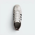 Focuses on the tidy lace closure, the clean alignment of the white leather tongue, and the high-definition perforations on the sockliner.