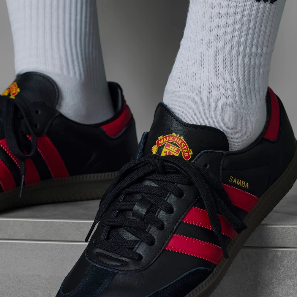 A close-up of the smooth leather grain and the precision stitching on the black T-toe.