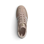 Direct overhead view of the shoe, displaying the suede T-toe overlay, flat taupe laces threaded through clean punched eyelets, textured white tongue crowned with the adidas Trefoil logo, and comfortable interior footbed.