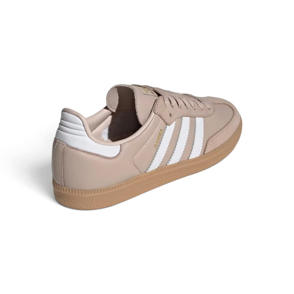 Close-up rear angle focusing on the Cloud White synthetic heel patch with printed Trefoil emblem, vertical heel spine seam, soft padded collar rim, and the textured gum rubber heel cup.