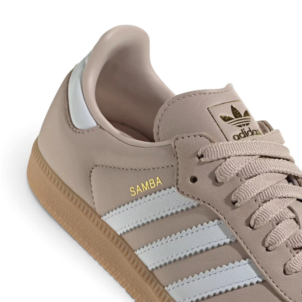 Macro view of the lateral midfoot perimeter, highlighting the textured gum rubber cupsole sidewalls, debossed sole wrap, and clean edge stitching along the white serrated 3-Stripes