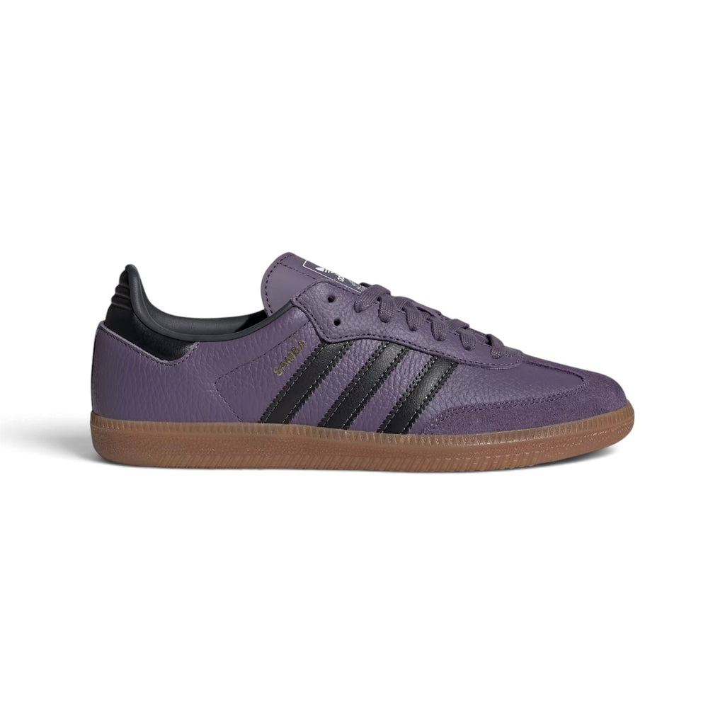 Side Profile Image: Studio lateral shot of the adidas Samba OG in Shadow Violet and Carbon, highlighting the textured purple tumbled leather upper, black serrated three stripes, gold foil SAMBA lettering, and the classic gum rubber outsole.   