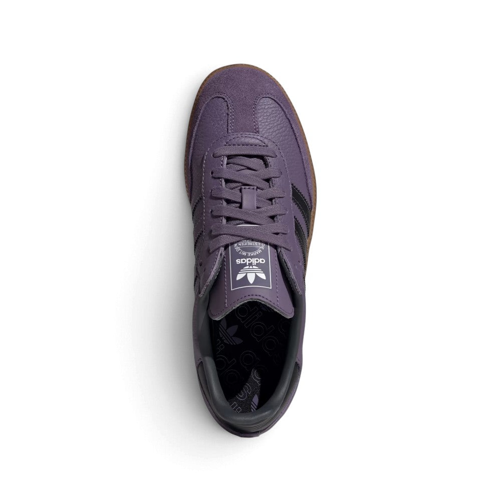 Top-Down View of Pair/Item: Overhead view looking down at the laced purple shoes, displaying the flat laces, tongue label with the white Trefoil logo, and the branded graphic insole.   