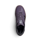 Top-Down View of Pair/Item: Overhead view looking down at the laced purple shoes, displaying the flat laces, tongue label with the white Trefoil logo, and the branded graphic insole.   