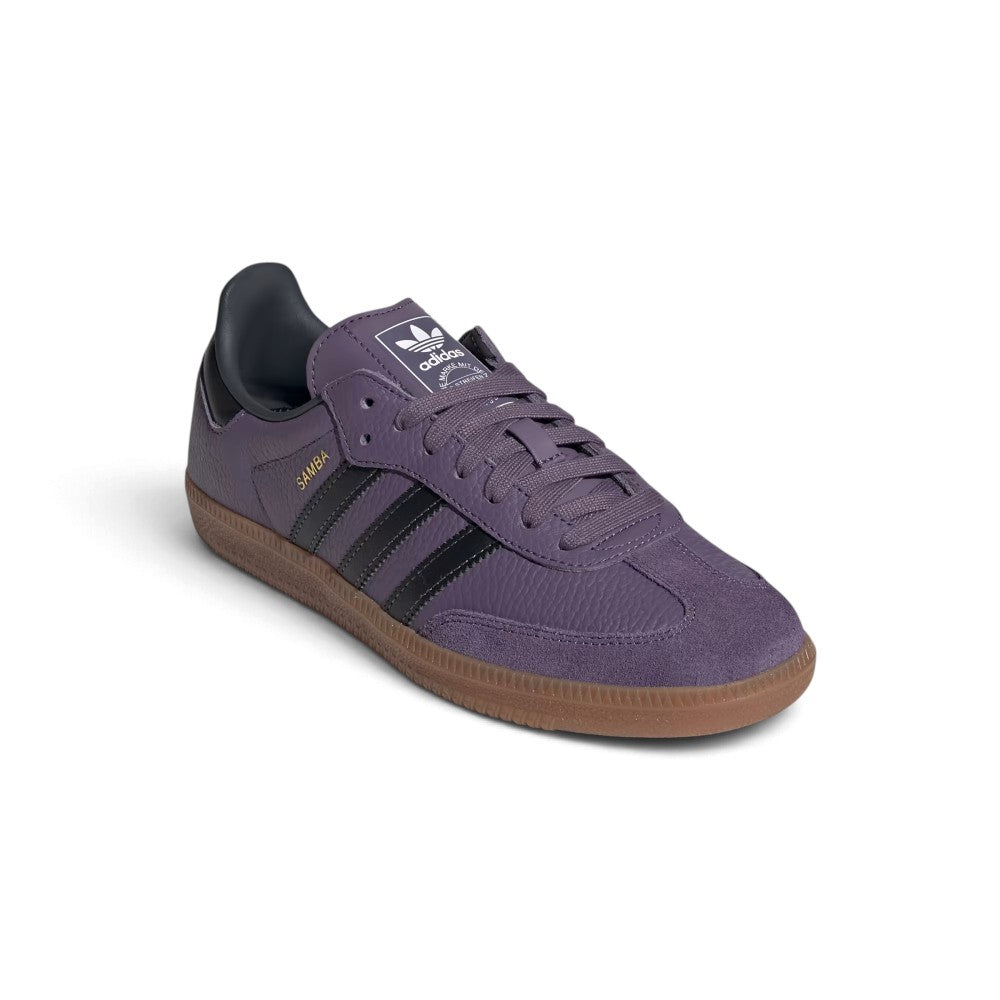 Angle View Showing Details Side by Side: Angled front-three-quarter perspective capturing the suede T-toe overlay, tumbled leather side panels, and contrasting carbon black stripes.   
