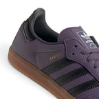 Zoom Looking at the Outsole and Midsole: Detailed close-up angle capturing the textured sidewall profile of the gum rubber midsole meeting the branded gold foil quarter panel.   