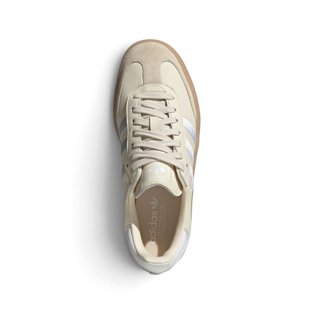 Top-Down View of Pair/Item: Overhead view looking down at the laced beige shoes, displaying the tonal flat laces, tongue label with embossed adidas branding, and clean branded insole.   