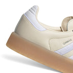 Zoom Looking at the Outsole and Midsole: Detailed close-up angle capturing the textured sidewall profile of the gum rubber platform midsole meeting the branded silver foil quarter panel.   