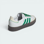 Focuses on the contoured shape of the green leather heel counter and the distinct, clean seam lines of the chunky platform rubber sole.