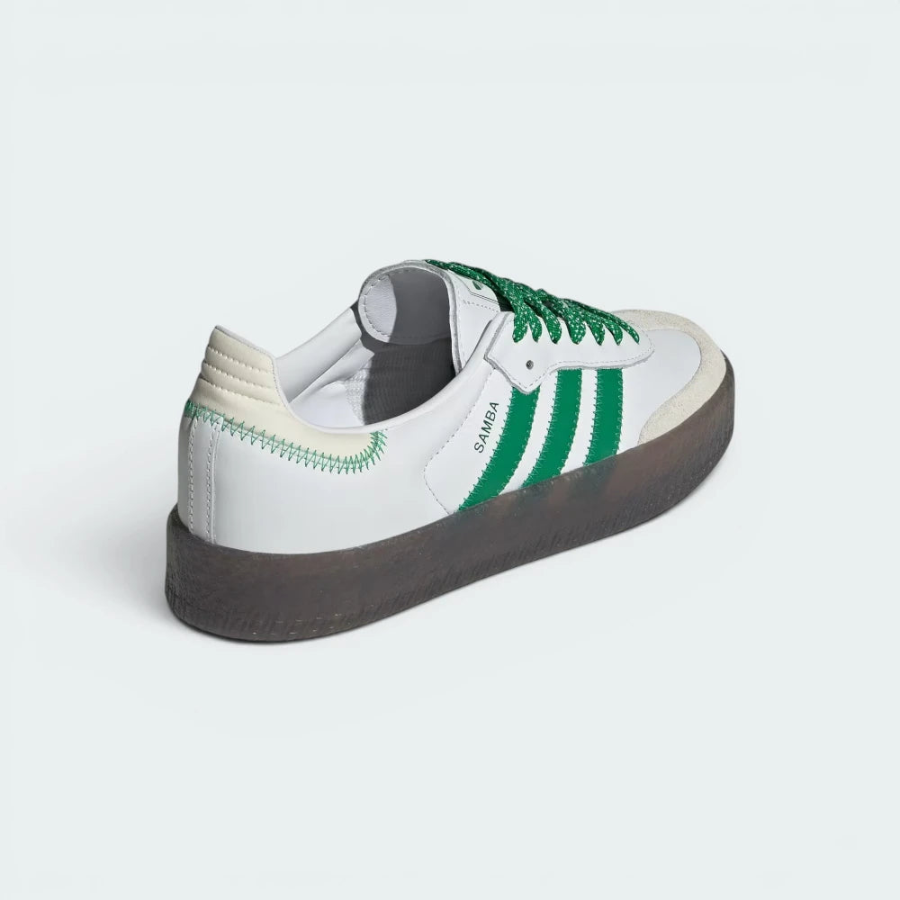 Focuses on the contoured shape of the green leather heel counter and the distinct, clean seam lines of the chunky platform rubber sole.