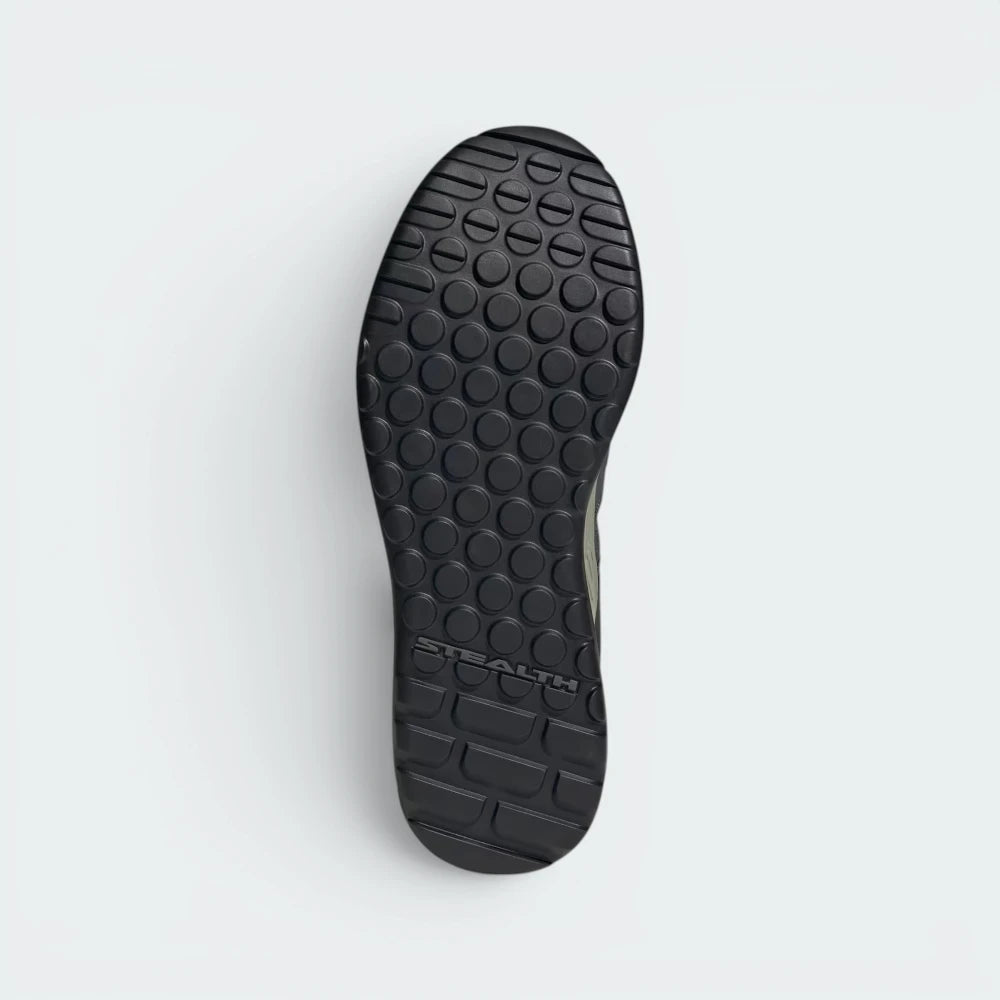 Displays the specialized flat-profile traction pattern of the solid Stealth Phantom rubber sole, showing the micro-dotty pedal grip zones and the segmented forefoot flex grooves engineered for unreal walking flexibility.