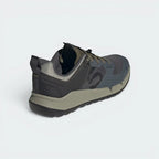 Focuses on the contoured shape of the mid-top ankle collar, highlighting the robust structural heel counter tracking down the rear spine to provide elite support during scrambling.