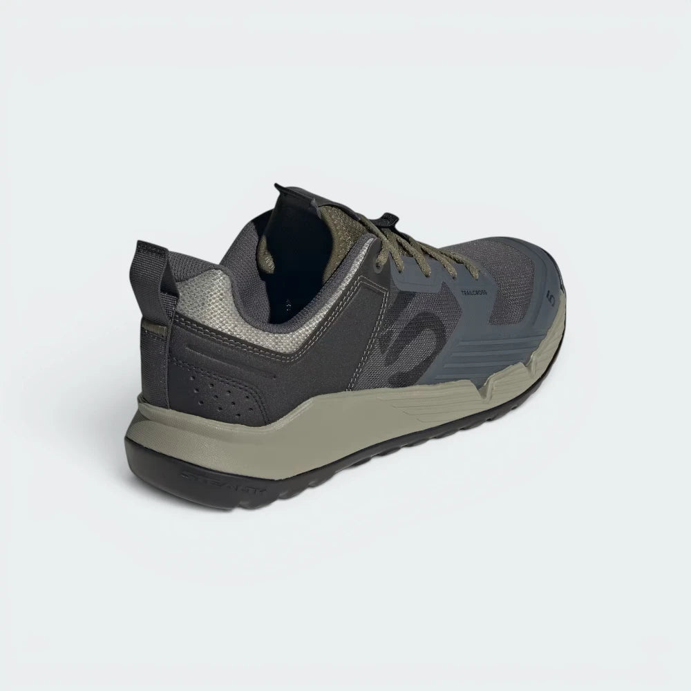Focuses on the contoured shape of the mid-top ankle collar, highlighting the robust structural heel counter tracking down the rear spine to provide elite support during scrambling.