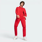 Person wearing a red tracksuit with a brand logo on a white background