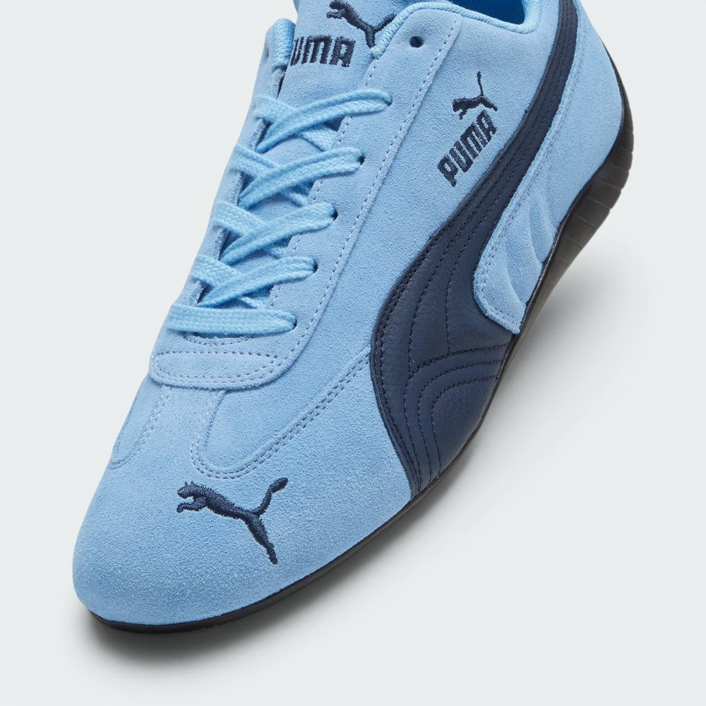 Details the high-definition suede grain and the precision of the toe embroidery.