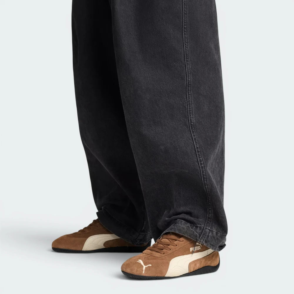 Highlights the technical solid midsole and the "unreal" finish of the gum-toned rubber.