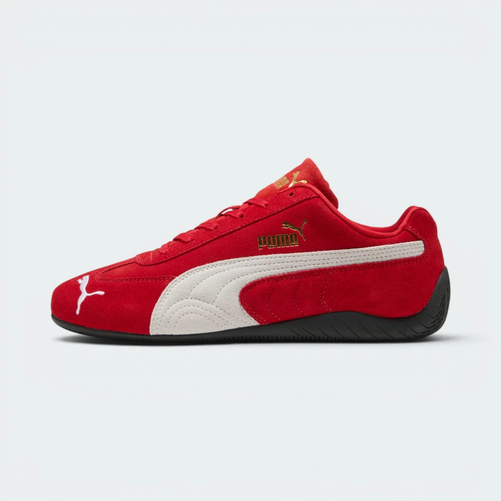 Highlights the high-velocity, low-slung silhouette of the shoe, showing the clean sweep of the white suede Formstrip against the vibrant red upper and the thin, textured black sole wrapping up the heel.