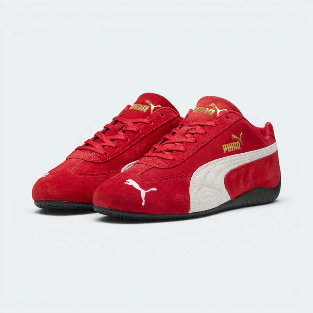 Emphasises the low-profile, forward-leaning athletic stance of the trainers, highlighting the classic sport harmony of the red suede and white leather accents.