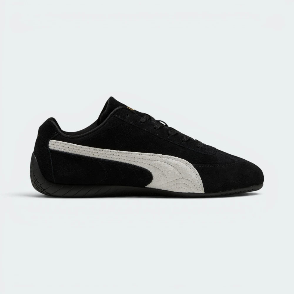 Highlights the high-velocity, low-slung silhouette of the shoe, showing the clean sweep of the white suede Formstrip against the black upper and the thin, textured black sole wrapping up the heel.