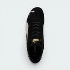 Focuses on the locked-in traditional lacing layout, displaying the clean symmetry of the black suede tongue, the gold foil Puma logo, and the breathable black OrthoLite® footbed inside.